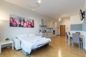 a bedroom with a bed and a table and a kitchen at 4 Star Family & Friends Apt - Self Check-in in Bologna