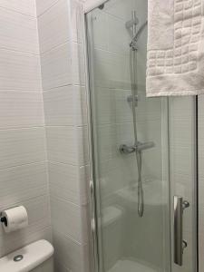 a shower with a glass door in a bathroom at Talbot Hotel in Stourbridge