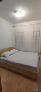 a bed in a room with a window at Apartment Valeriana in Herceg-Novi