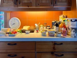 a kitchen counter with food and a clock on it at Egen stuga med delat badrum in Norrtälje +14 photos