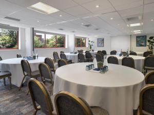 a conference room with white tables and chairs at Delta Hotels by Marriott Swindon in Swindon +50 photos
