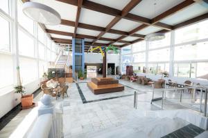 a lobby with a staircase and tables and chairs at Destinos de Sol La Minería Roquetas de Mar in Roquetas de Mar