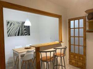 a kitchen with a table and chairs and a dining room at Apartamento Vila de Neda in Neda