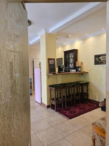 a living room with a counter and a table at Barrister's apartments with fireplace in Šiauliai