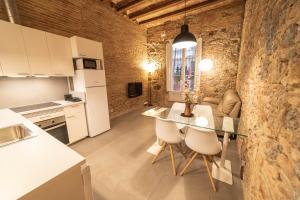 a kitchen and living room with a table and chairs at Apartments Gaudi Barcelona in Barcelona