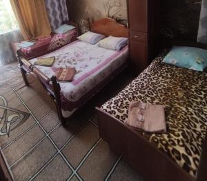 a bedroom with two beds and auggage at Petrovskaya Pristan 2 in Cholpon-Ata