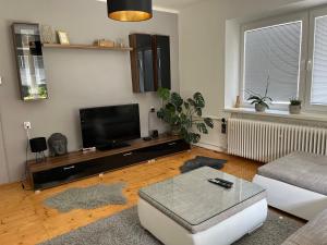 a living room with a flat screen tv and a couch at Privat in Liptovský Ján