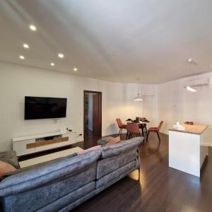 a living room with a couch and a table at NewPearl Apartman in Sopron