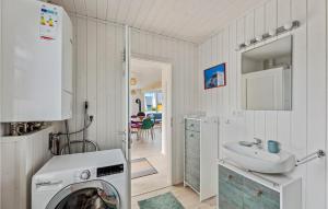 a kitchen with a washing machine and a sink at Lovely Home In Zerpenschleuse With Wifi in Berg