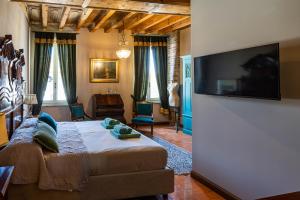 une chambre avec un lit et une télévision à écran plat dans l'établissement B&B Formigola, à Corticelle Pieve