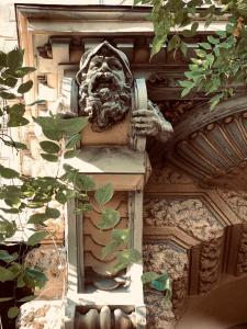 a statue of a face on the side of a building at Teresa Apartment in Budapest