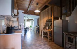 a kitchen with a refrigerator and a table at Awesome Home In Rokovci With Outdoor Swimming Pool 