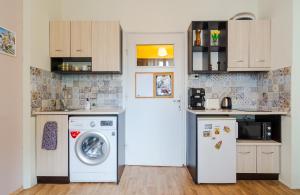 a kitchen with a washing machine and a washer at The Top Spot - Cute Little Studio in the Center by Flat Mаnager in Sofia +4 photos