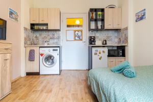 a small kitchen with a washing machine and a washer at The Top Spot - Cute Little Studio in the Center by Flat Mаnager in Sofia