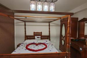 a bedroom with a bed with a heart decoration on it at Day One Studio Apartment in Madurai