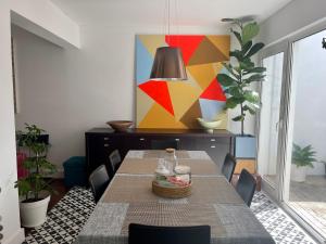 a dining room with a table and chairs at Casa Amiluz in Ponta Delgada