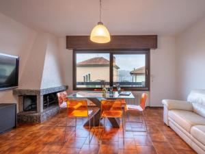 a living room with a table and a fireplace at Spaghetti & Cappuccino Beach Villa in Pella