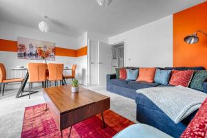 a living room with a blue couch and a table at Luxurious Birmingham Home Private Parking WiFi - near to NEC and QEH in Longbridge
