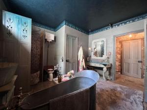 a large bathroom with a tub and a sink at Seasoned Grandeur Home in Faversham