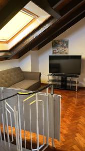 a living room with a couch and a flat screen tv at Garden Apartment in Baden-Baden