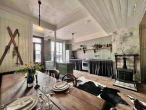 a dining room with a table and a fireplace at Seasoned Grandeur Home in Faversham