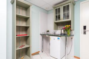 a kitchen with a counter and a refrigerator at Hotel Dzingel in Tallinn