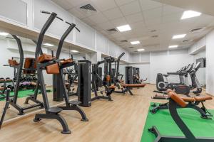 a gym with treadmills and elliptical machines at Khreschatyk Hotel in Kyiv