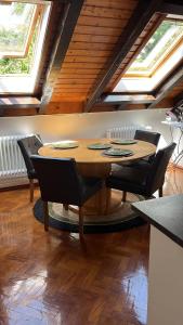a wooden table and chairs in a room at Garden Apartment in Baden-Baden