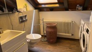 a small bathroom with a toilet and a radiator at Garden Apartment in Baden-Baden