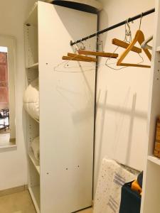 a closet with a white door and some hangers at ferme st pierre suite, piscine, clim, repas, cheminée in Chabeuil