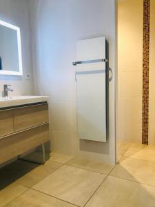 a bathroom with a refrigerator and a sink at ferme st pierre suite, piscine, clim, repas, cheminée in Chabeuil