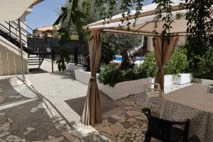 a patio with a table and a canopy at The Dream Holiday Room in Belicena