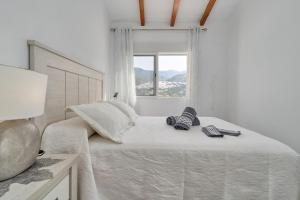 a bedroom with a bed with two remote controls on it at Entre montañas in Árchez +27 photos
