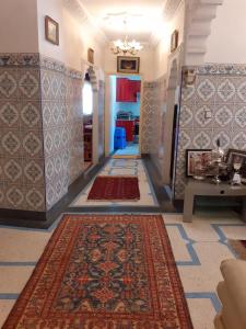 a hallway with colorful rugs on the walls and a hallway with at Bel Appartement à El kelaa Des Srarhna in El Kelaa des Srarhna