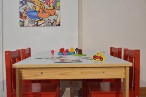 a wooden table with childrens toys on top of it at Retraite au lac avec SPA privé et embarcations in Saint Adolphe D'Howard