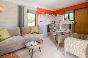 a living room with a couch and a table at Mission Lodge in Thorpeness