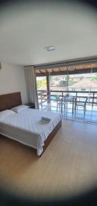 a bedroom with a bed and a table and chairs at Casa com piscina e sauna em Petrópolis in Petrópolis