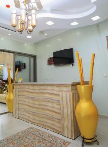 two large yellow vases sitting in a salon at ALLY NGALI MOTEL in Kigali