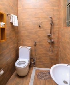 a bathroom with a toilet and a sink at ALLY NGALI MOTEL in Kigali