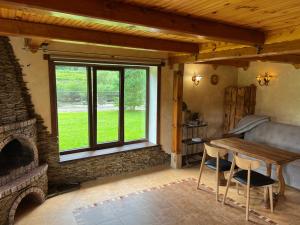 a living room with a table and a large window at Zatin in Yaremche