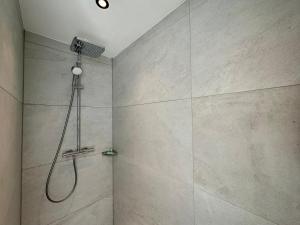 a bathroom with a shower with a shower head at Hotel Emilia in Würzburg