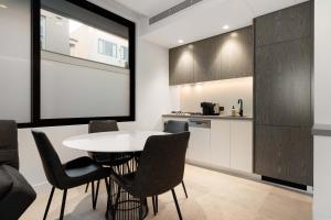 a kitchen and dining room with a table and chairs at THE SHORE COOGEE BEACH (3) in Sydney