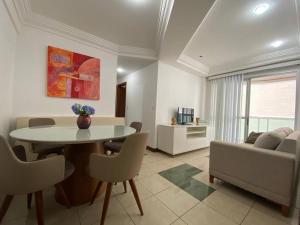 a living room with a table and a couch at PRAIA DA COSTA - 02 QUARTOS - SOL E MAR in Vila Velha