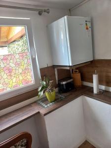 a kitchen with a counter top with a window at Bungalow Hugo in Oppach