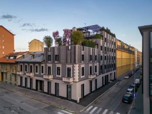a building with trees on top of it on a street at LA CASA DI MALU Apart Hotel : Elegant Flats in Turin