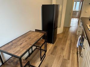 a kitchen with a table and a refrigerator at MM Lodge - Apartments in Innenstadtlage mit Parkplatz in Augsburg