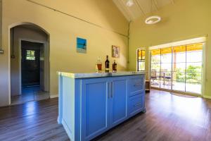 a kitchen with a blue island in a room at Natural Mystic 