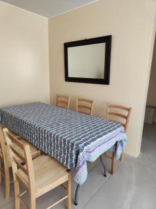 a table with chairs and a blue and white table cloth at Apartamento Florentino 101 in Lima