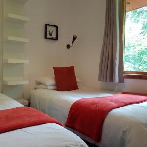 Ένα ή περισσότερα κρεβάτια σε δωμάτιο στο Hawthorn Lodge