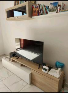 a flat screen tv sitting on top of a wooden stand at CASA GRIMA - private double room in Birkirkara